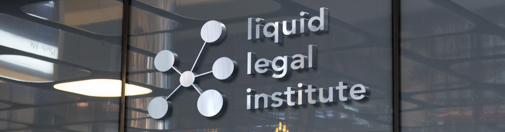 photo of iron company logo of liquid legal institute on a wall